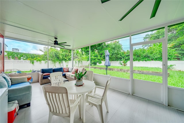 sunroom with a wealth of natural light and ceiling fan