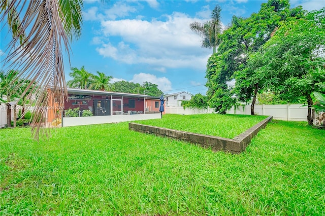 view of yard with a sunroom