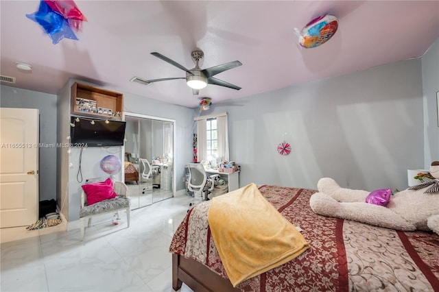 bedroom with ceiling fan and a closet