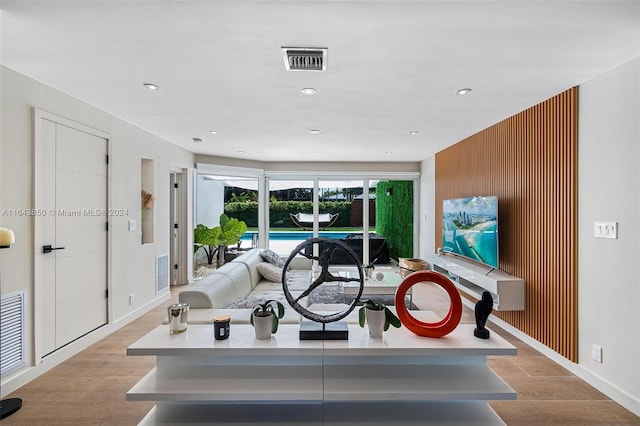 living room featuring wood walls and light hardwood / wood-style floors