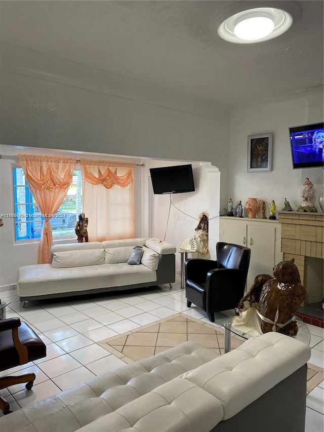 living room with a textured ceiling and light tile patterned flooring