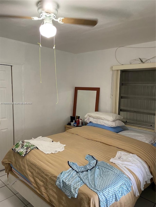 bedroom with light tile patterned floors and ceiling fan