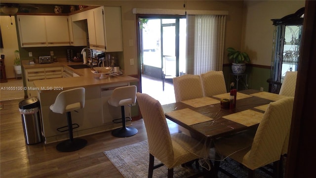 dining room featuring wood-type flooring and sink