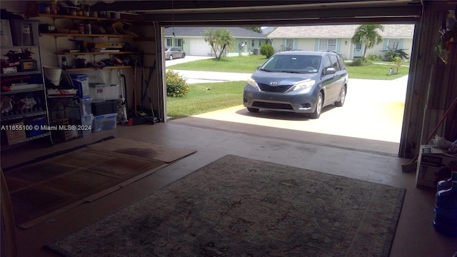 garage with a yard and a carport