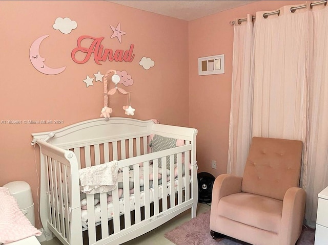 bedroom featuring a nursery area