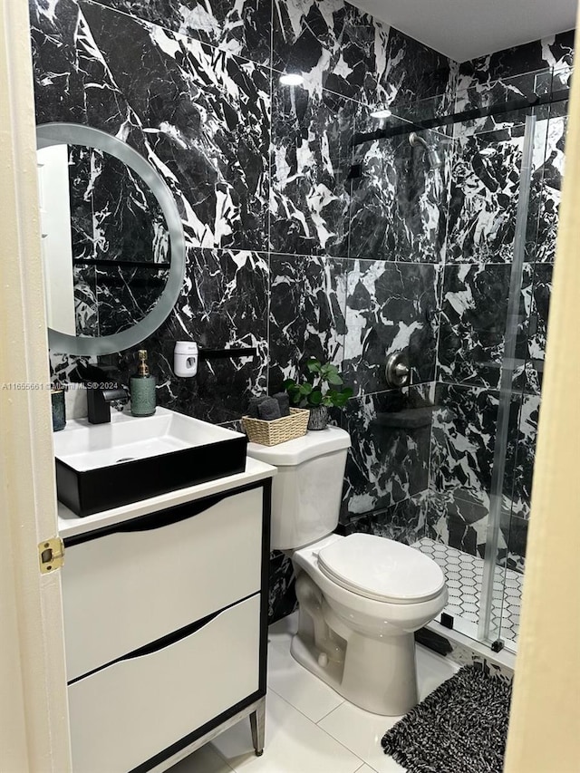 bathroom featuring tile patterned floors, walk in shower, toilet, tile walls, and vanity