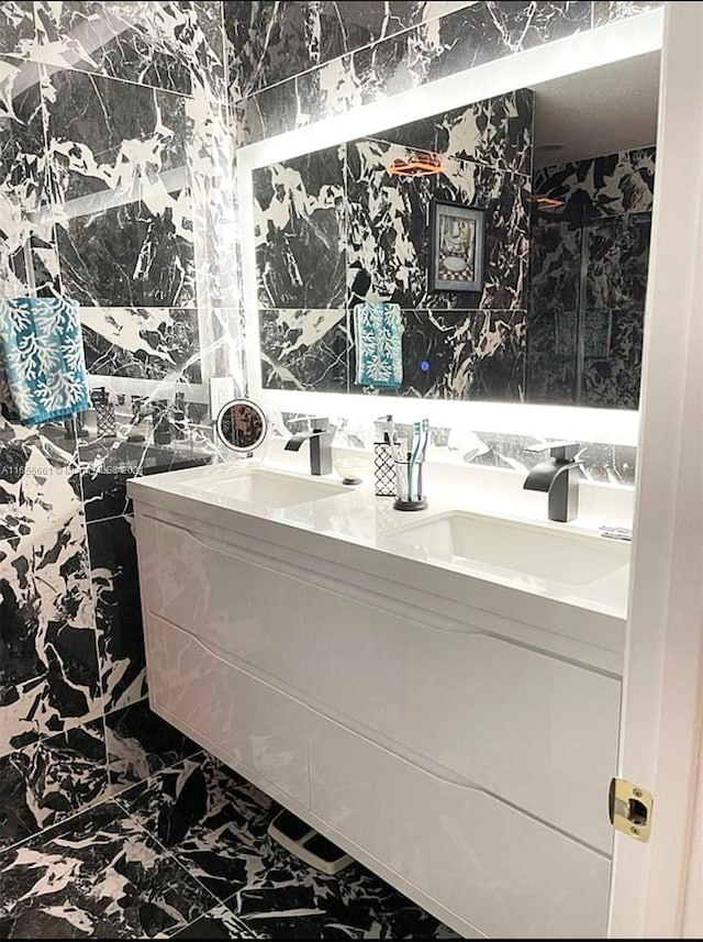 bathroom featuring vanity and tile walls