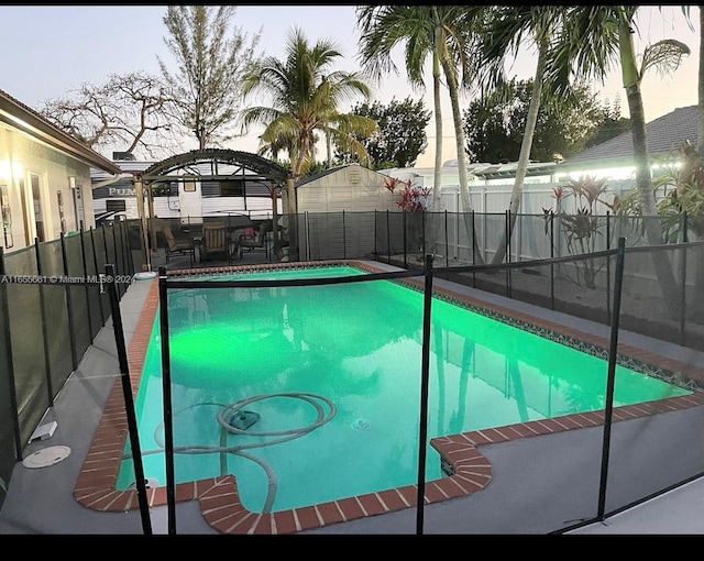 pool at dusk featuring a gazebo