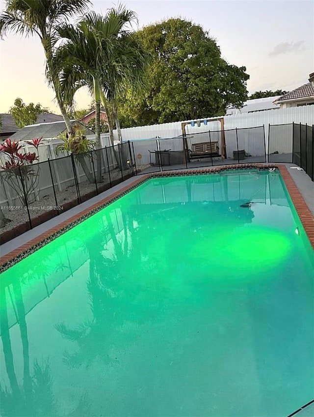 view of pool at dusk