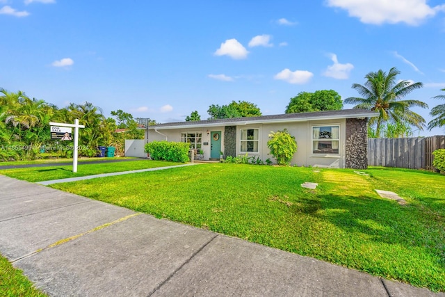 ranch-style home featuring a front yard