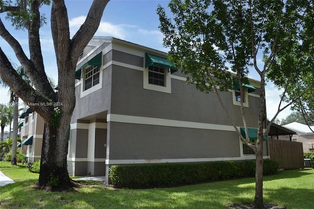 view of side of home with a lawn