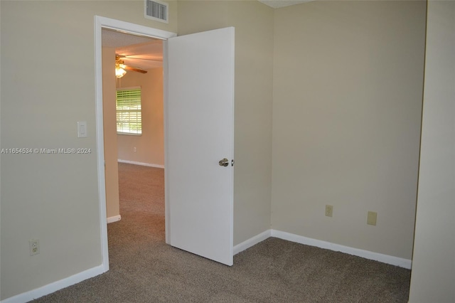 spare room with ceiling fan and carpet flooring