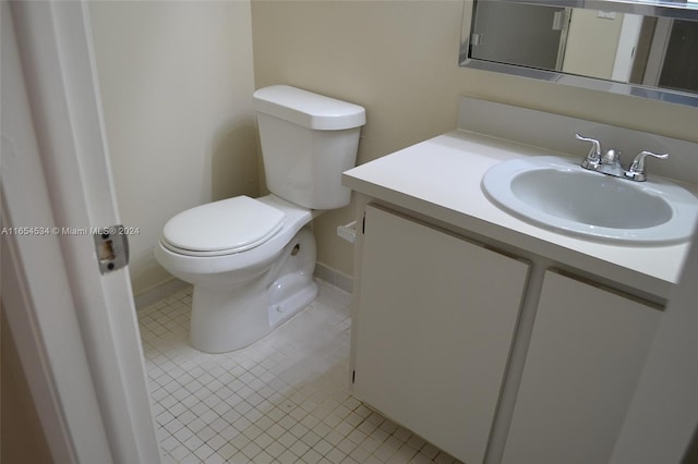 bathroom featuring vanity, toilet, and tile patterned flooring