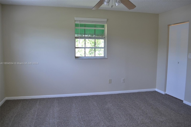 unfurnished room with ceiling fan, a textured ceiling, and carpet floors