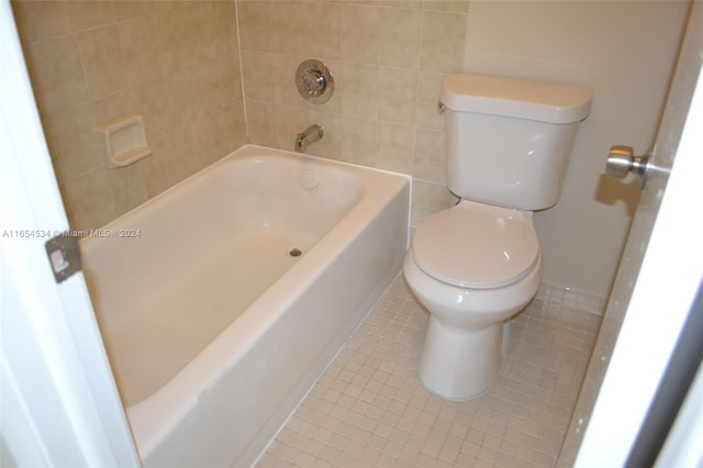 bathroom featuring toilet, shower with separate bathtub, and tile patterned flooring