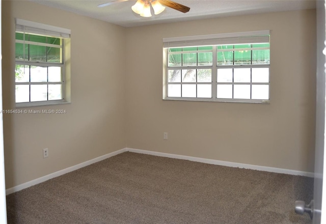 carpeted empty room featuring ceiling fan