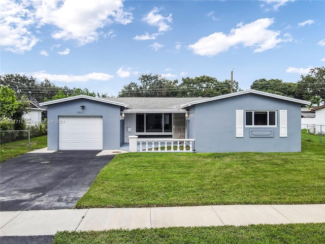 ranch-style home featuring a front lawn and a garage