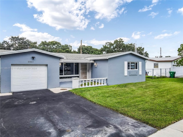 single story home with a garage and a front lawn