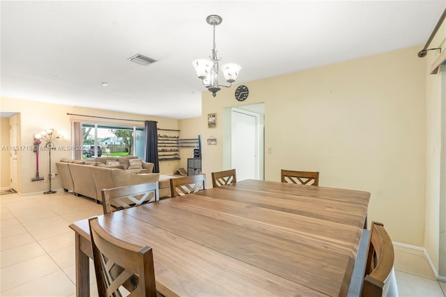 tiled dining space with a notable chandelier