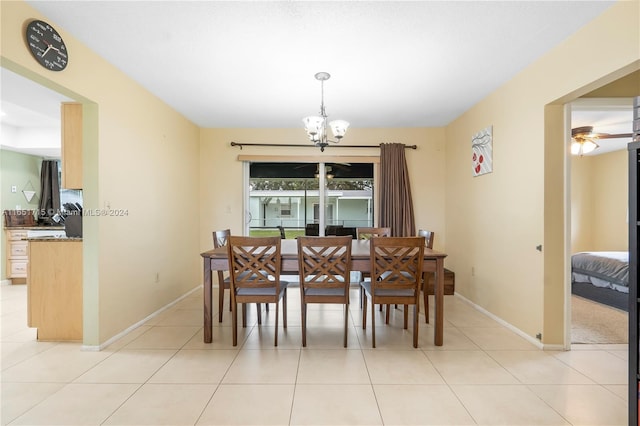 dining area featuring ceiling fan with notable chandelier and light tile patterned flooring