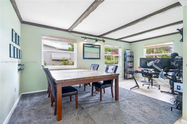 carpeted dining room with beamed ceiling