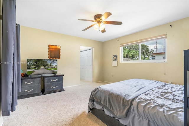 bedroom with a closet, ceiling fan, and carpet floors