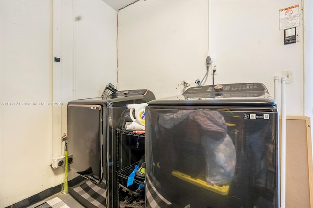 clothes washing area with washing machine and clothes dryer