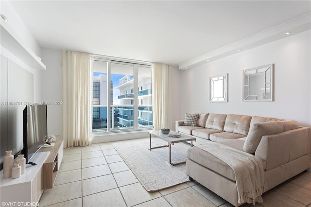 living room with expansive windows, light tile patterned floors, and a healthy amount of sunlight