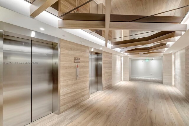 interior space featuring light wood-type flooring and elevator