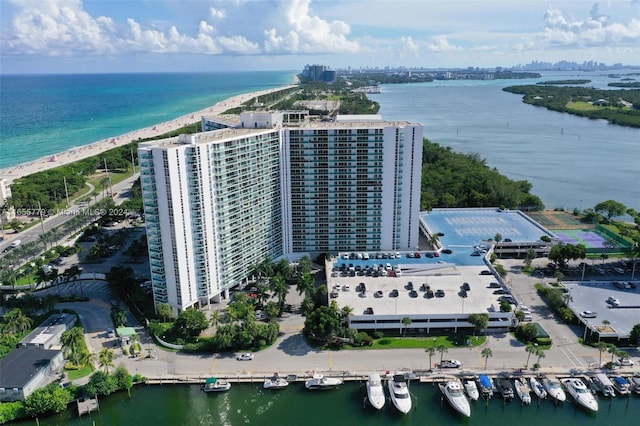 bird's eye view featuring a water view and a beach view