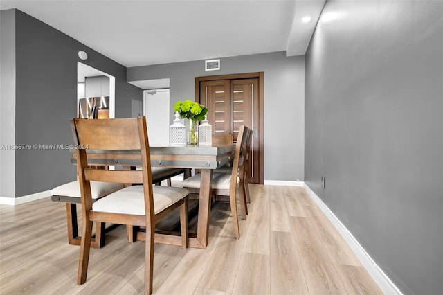 dining space with light wood-type flooring