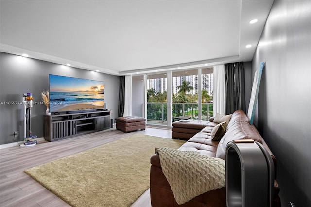 living room with floor to ceiling windows and light hardwood / wood-style flooring