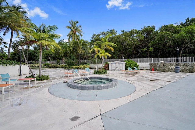 view of pool with a community hot tub and a patio area