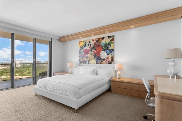 bedroom featuring a wall of windows, access to exterior, and carpet