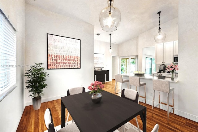 dining space with light hardwood / wood-style flooring and high vaulted ceiling