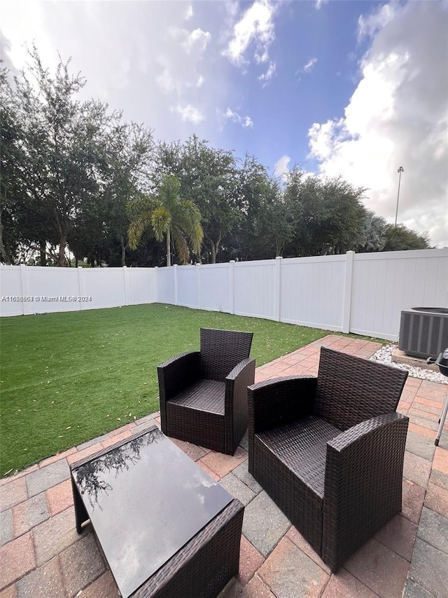 view of patio / terrace with a fenced backyard and central AC