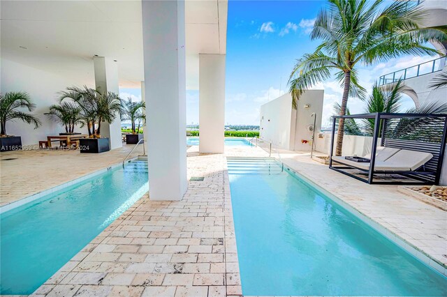 view of swimming pool with a patio