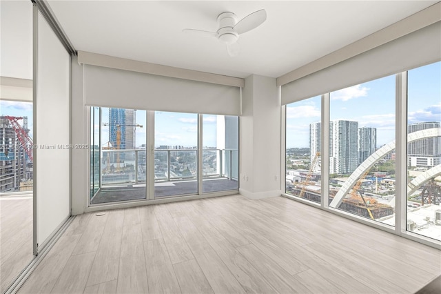 spare room with ceiling fan and light hardwood / wood-style flooring