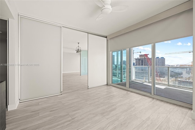 empty room featuring ceiling fan and light hardwood / wood-style floors