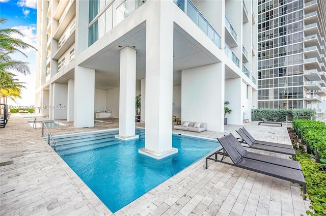 view of swimming pool featuring a patio area