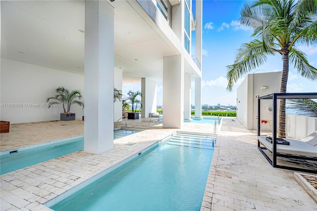 view of swimming pool with a patio area