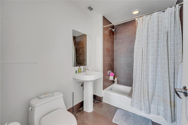 full bathroom with tile patterned flooring, sink, toilet, and shower / bath combo with shower curtain