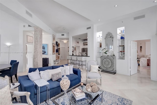 living room featuring ornate columns