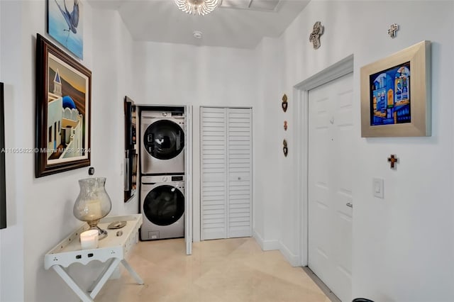 laundry area featuring stacked washer / drying machine