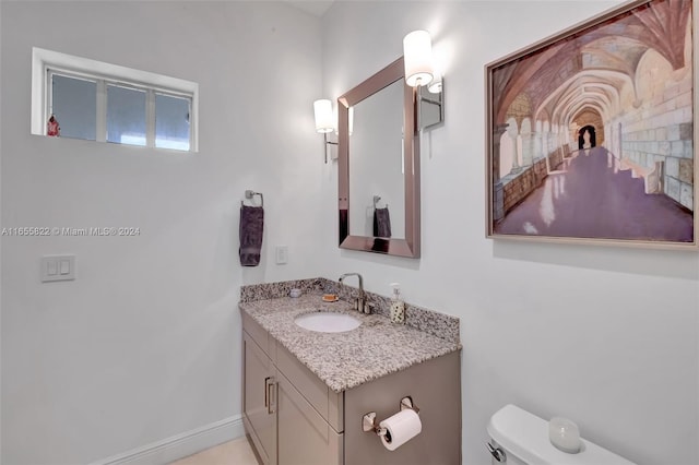 bathroom with toilet and vanity