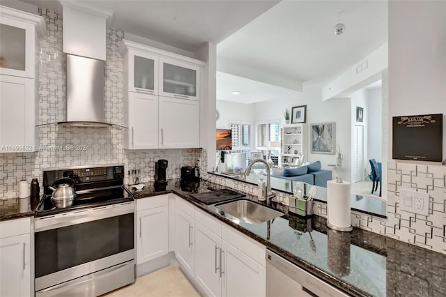 kitchen featuring dark stone countertops, sink, appliances with stainless steel finishes, and white cabinetry