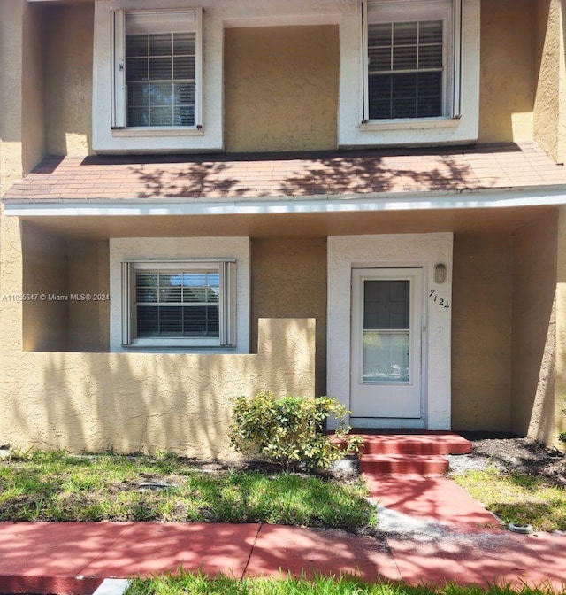 view of exterior entry with a porch