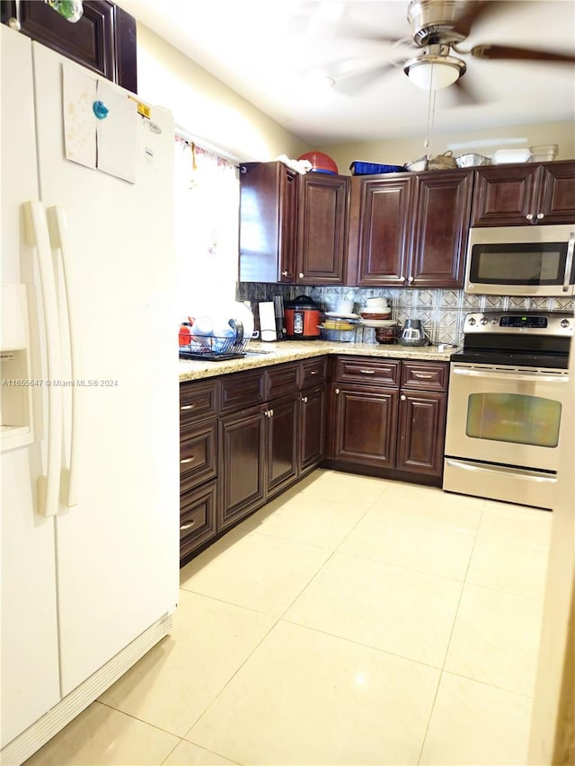 kitchen with light tile patterned floors, appliances with stainless steel finishes, light stone countertops, ceiling fan, and decorative backsplash