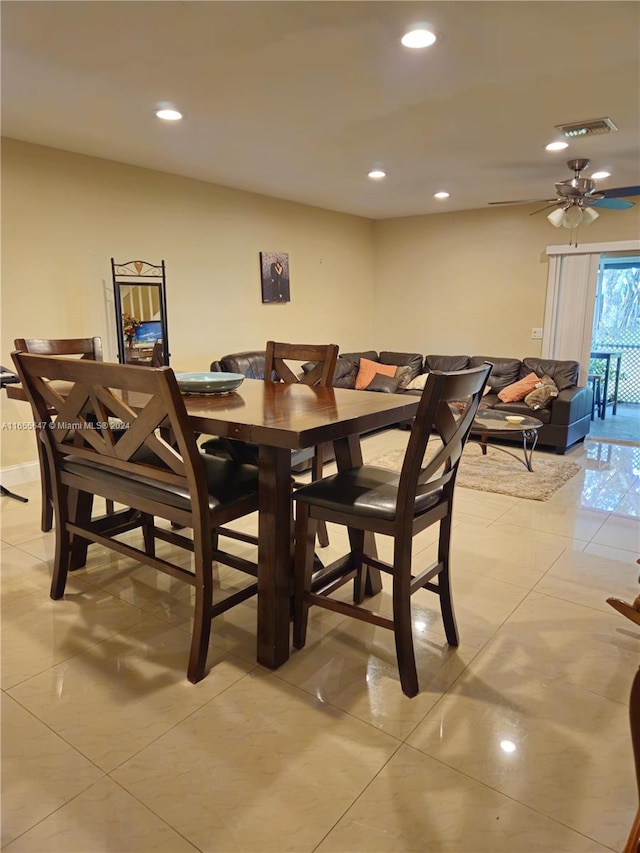 tiled dining room featuring ceiling fan