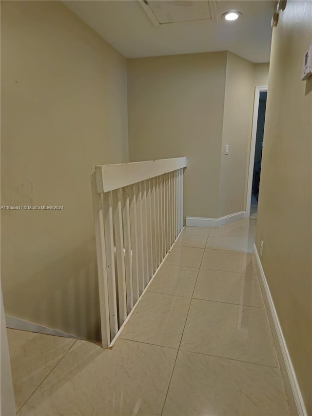 corridor with light tile patterned flooring